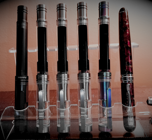 5 Asvine V200's filled with Diamine Jet Black, Oxford Blue, Aurora Borealis, Writer's Blood and Imperial Purple inks. To their right is the Jinhao x750 filled with Wordsworth & Black Lavender Purple.