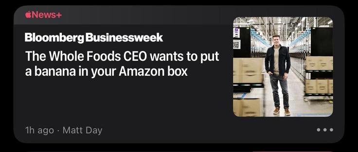A screencap of an Apple News bubble with a picture of the Whole Foods CEO in what appears to be a warehouse. The caption reads “Whole Foods’ CEO Wants to Put a Banana in Your Amazon Box”