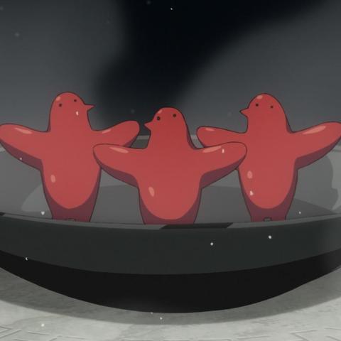 Three red sort of bird shaped "familiars" standing upright in a pan.