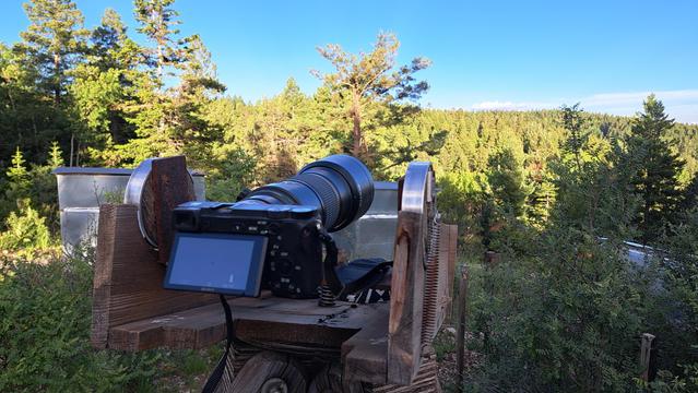 Waiting for the moon to rise. The distant trees are in full sunlight.

The camera is mounted on an old, weathered wooden tripod that normally carries big binoculars.