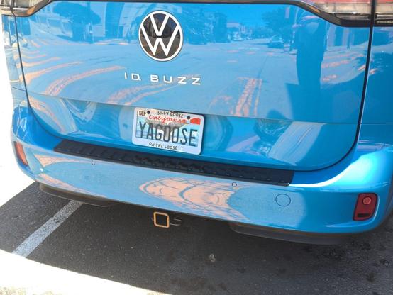 Blue Id Buzz Volkswagen bus with vanity plate and matching frame

License plate frame: Silly Goose on the Loose
Plate: YA GOOSE