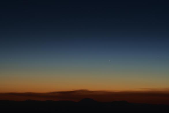 In bright twilight brilliant Venus stands out in the frame, but to the right are two stars: Castor and Pollux in Gemini.

The band of brown-orange 'clouds' hugging the horizon is a plume of smoke from Sacaton fire in the Gila wilderness.

https://share.watchduty.org/i/103964?ts=1782878147000