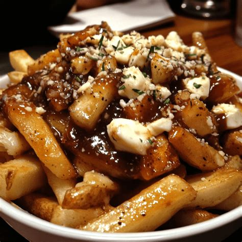 Plate of poutine, consisting of french fries, cheese curds and gravy.