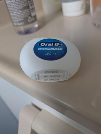 A container of floss that expires in 2029.