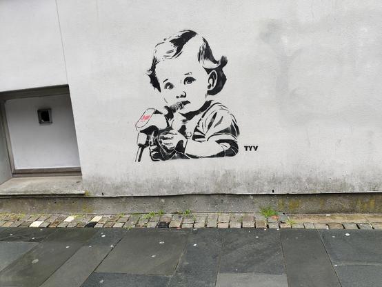 Street art in style of banksyn, with little girl drinking from gasoline nozzle
