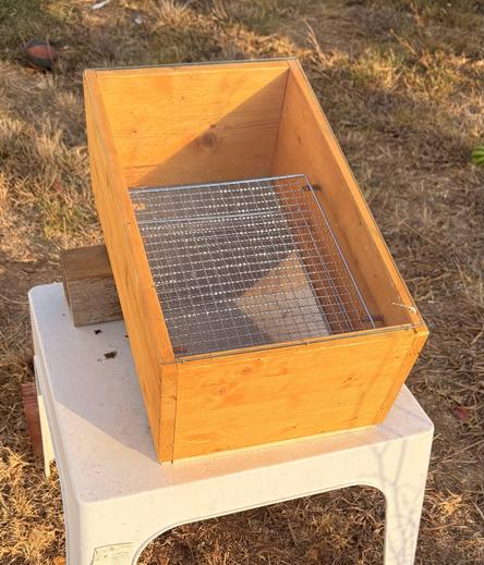 Photo of the finished solar wooden dehydrator standing in the sun with all parts assembled.