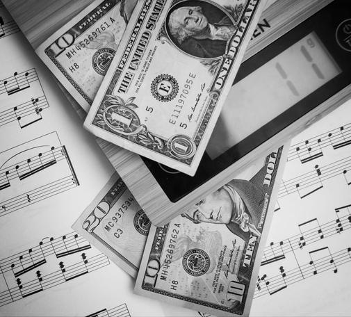So this image - there is a musical score upon which there is a modern electronic set of kitchen scales.  On the scales are a 10  US dollar bill and 1 US dollar bill.  The scale is registering 11 grams in weight.  Between the scales and musical score are a 10 US dollar bill and a 20  US dollar bill.  If you can't work it out, it's notes on a scale.  Best I could come up with TBH.