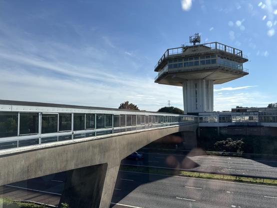 The brutalist hexagonal tower at Lancaster (Forton) Services, as seen from the other side of the motorway, and with the footbridge alongside us.