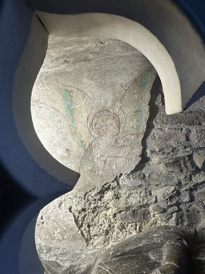 Lines of angel beyond a tomb