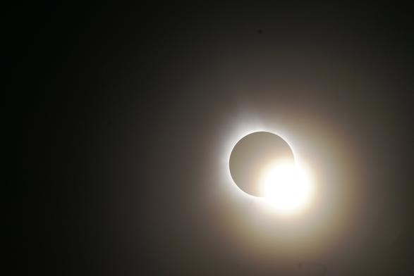 Same image except the bottom right now has progressed into the "diamond ring" where extremely bright light is slowly swallowing the darkness.