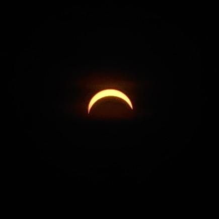 Solar eclipse almost full, with a thin crescent on the top