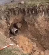 A pipe, heavily clogged with mud that is being extruded out forcefully, not unlike the extrusions you might do after your first cup of coffee of the day