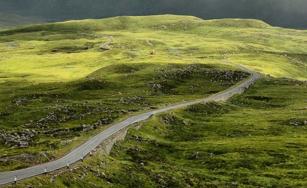 Bin lorry in the distance on a single track road.