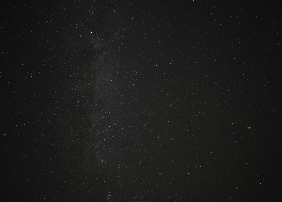 Looking straight up at the Milky Way stretched across a perfectly dark star-filled sky.